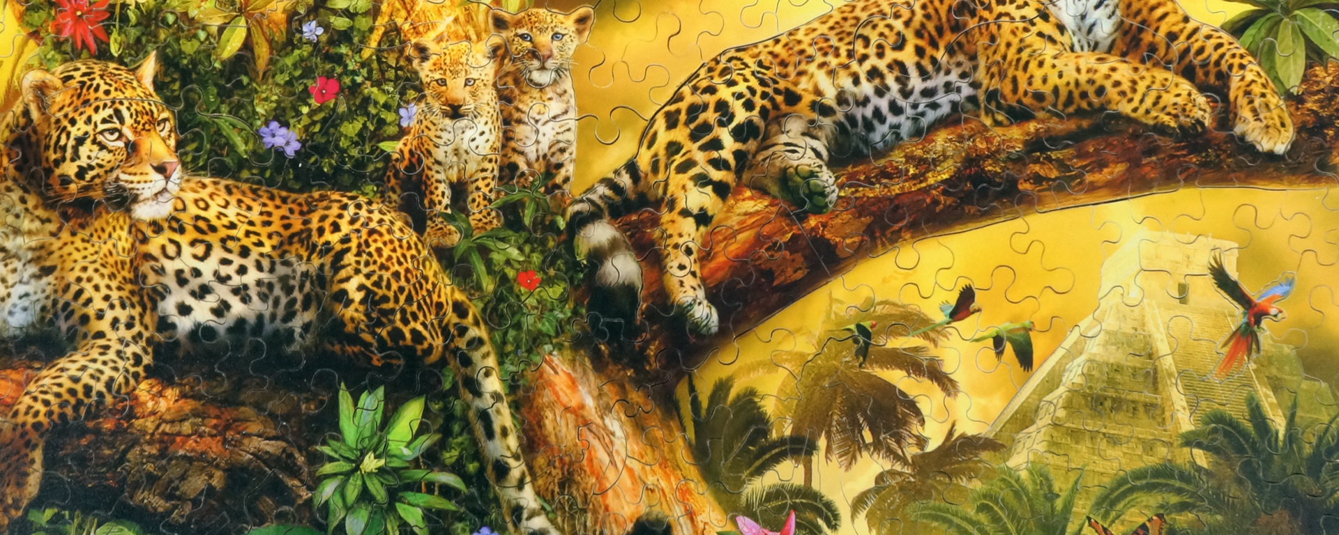 Wooden rainforest jigsaw puzzle featuring 2 adults leopards and 2 leopard cubs lounging in a tree.
