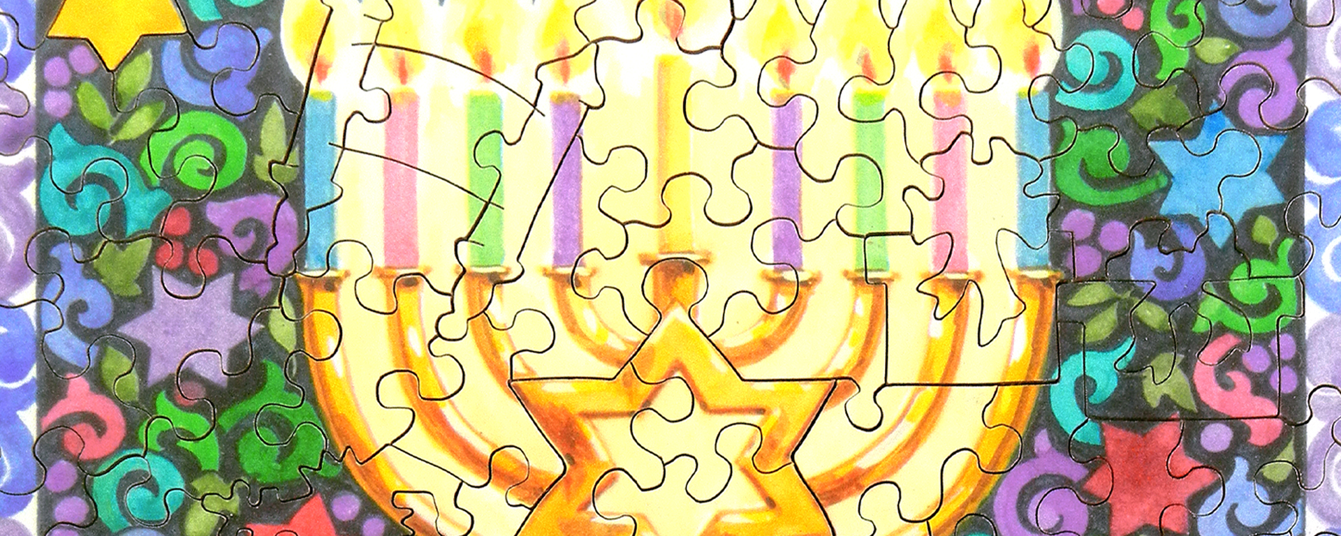 Wooden jigsaw Hanukkah puzzle of a Menorah with lit candles surrounded by colorful patterns.