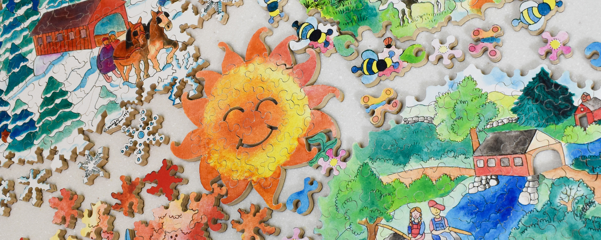 Wooden seasons puzzle in progress depicting all 4 of the seasons with a big smiling sun in the middle.