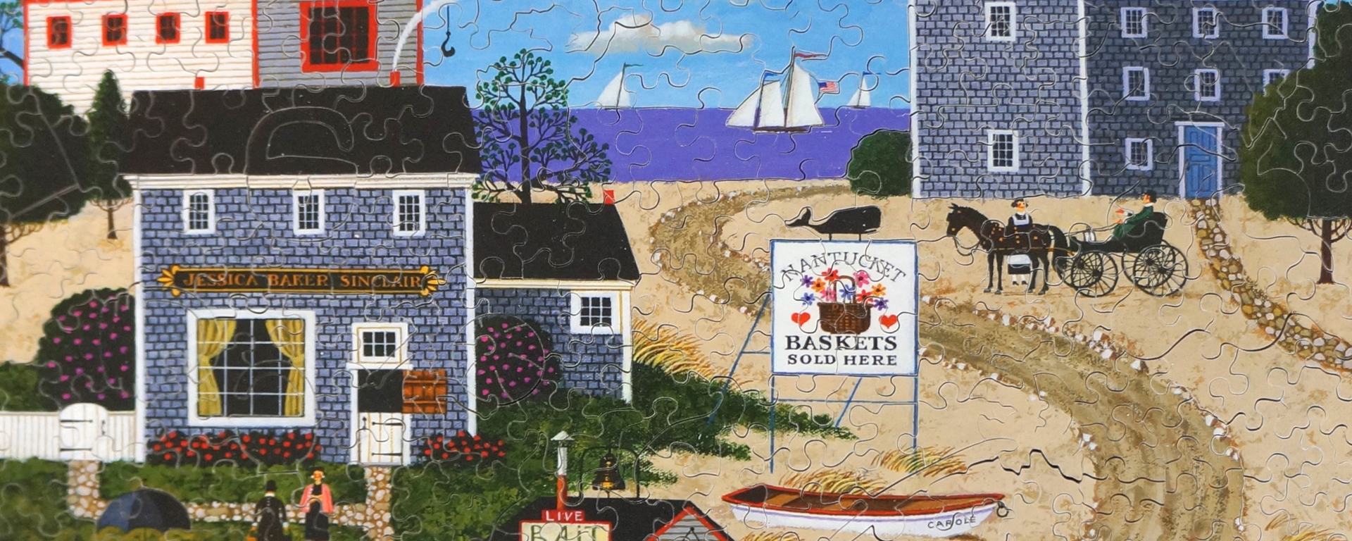 Wooden summer puzzle of Nantucket Breeze by Charles Wysocki depicting seaside shops on Nantucket Beach.