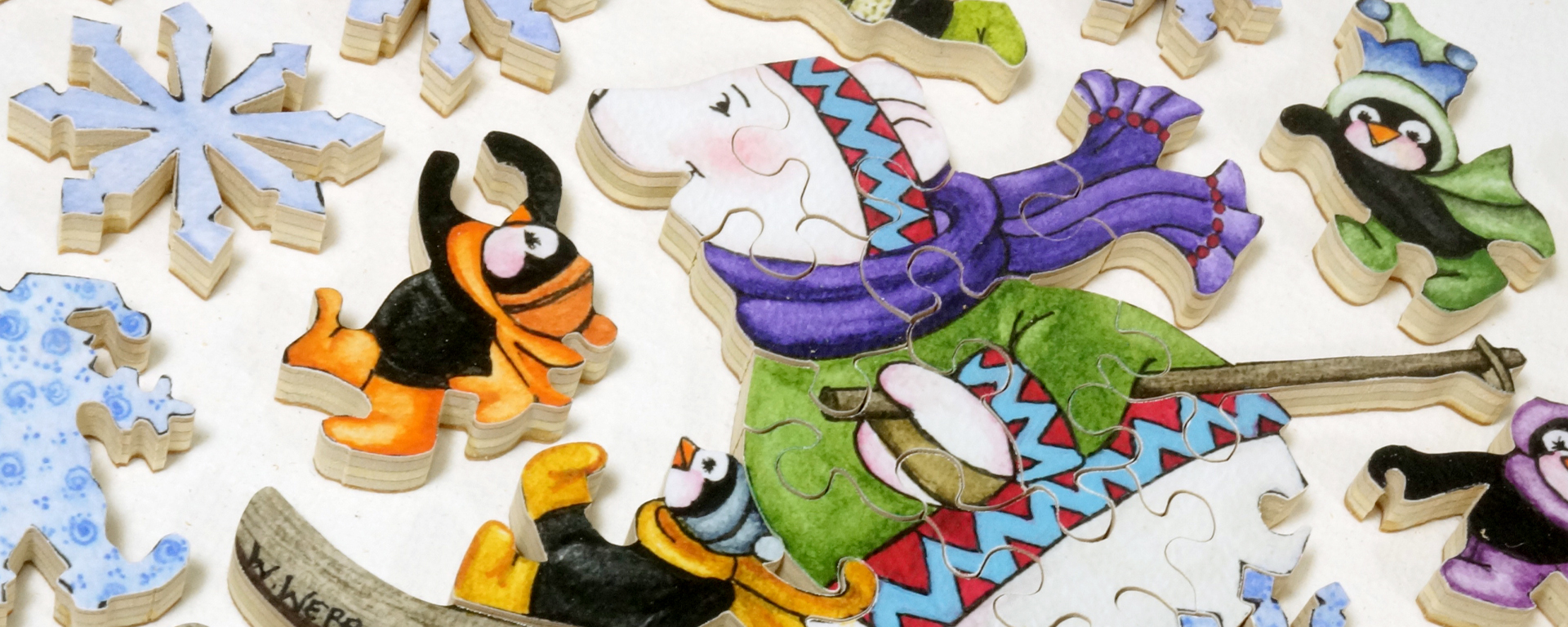 Wooden winter puzzle of a skiing bear surrounded by adorable penquins in hats, scarves, and boots.