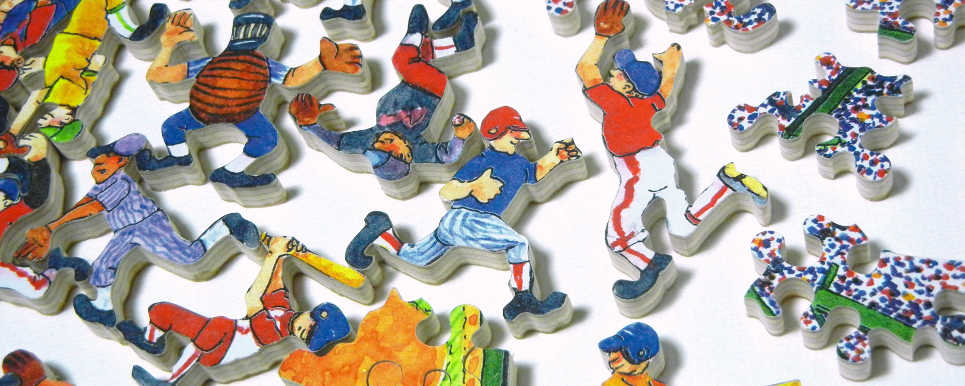Wooden baseball puzzle in progress with whimsy shaped pieces shaped like baseball players.