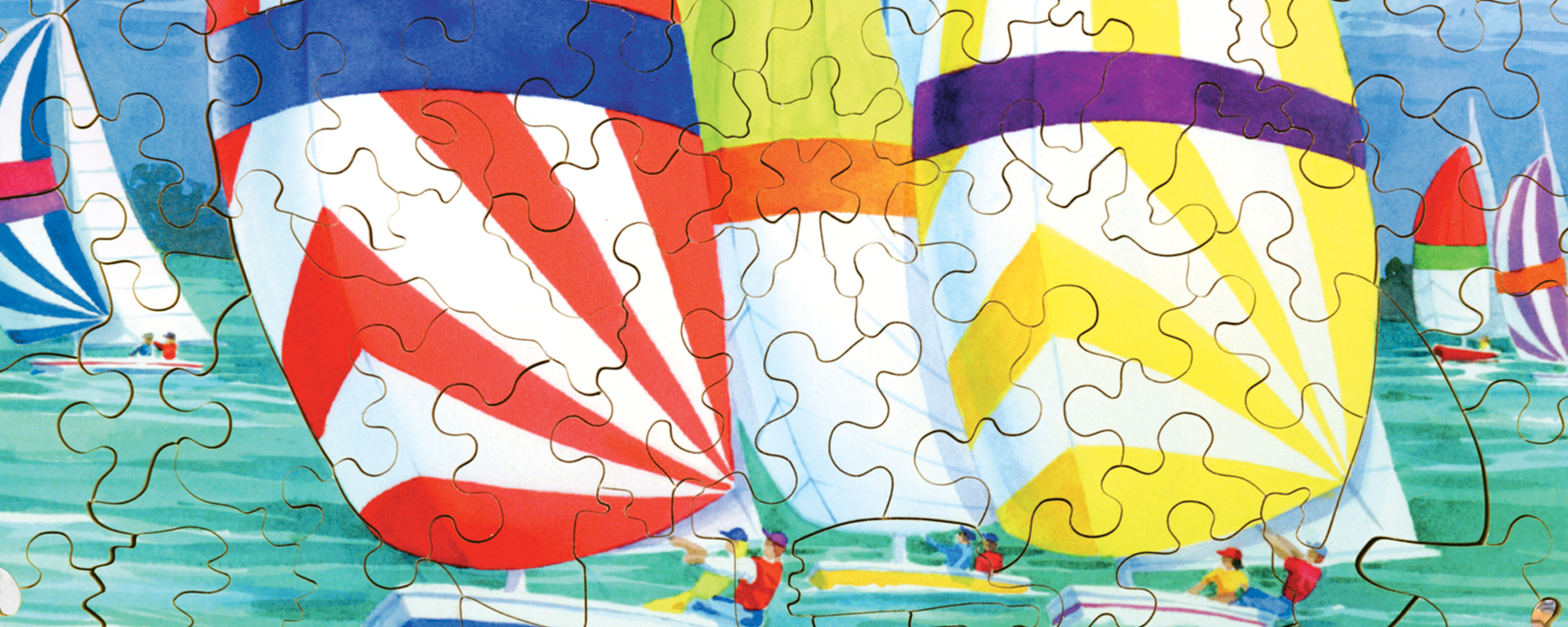 Wooden boating and sailing puzzle featuring a bunch of sail boats on the water with brightly colored sails.