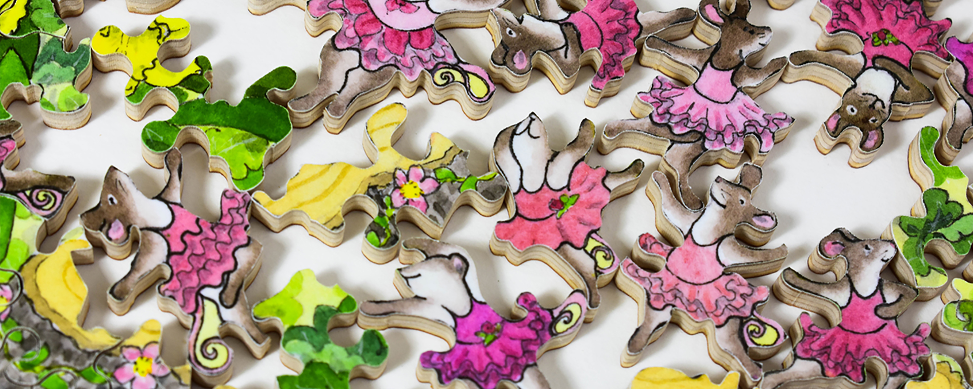 Wooden dance puzzle in progress featuring many dancing mice in pink tutu leotards.