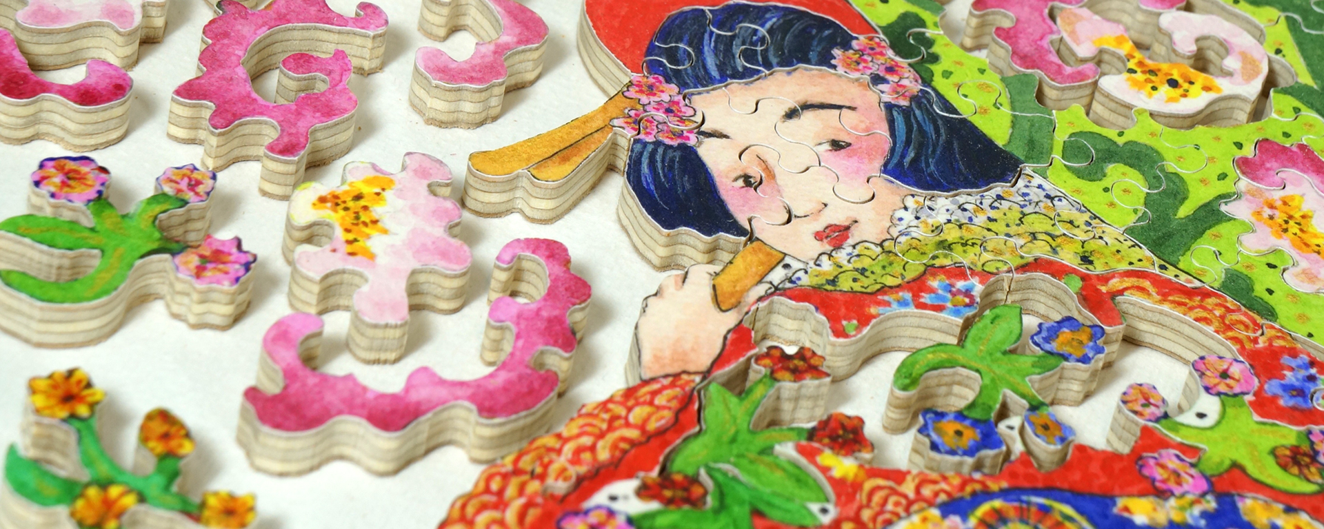 Wooden teaser puzzle of a woman wearing a colorful kimono holding an umbrella with cherry blossoms on the top.
