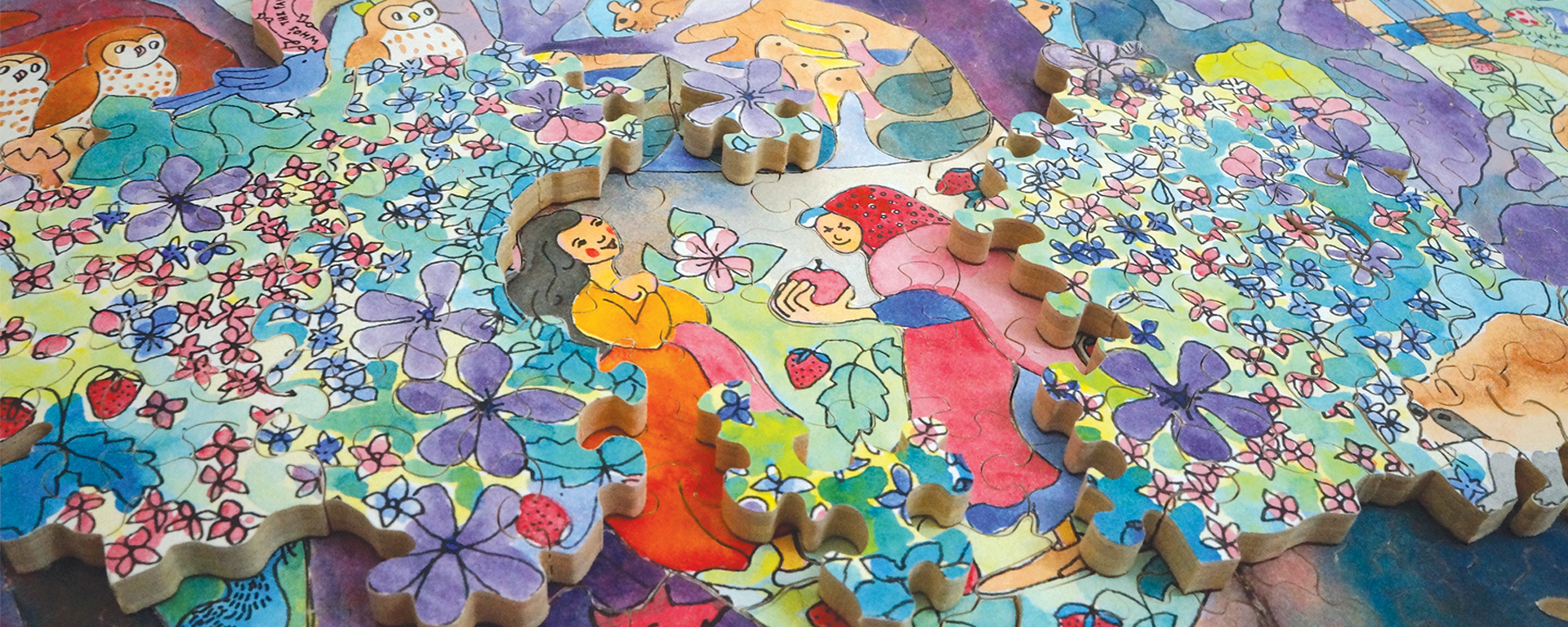 Wooden jigsaw puzzle depicting a woman in the forest surrounded by woodland animals and flowers and an old woman offering her an apple.