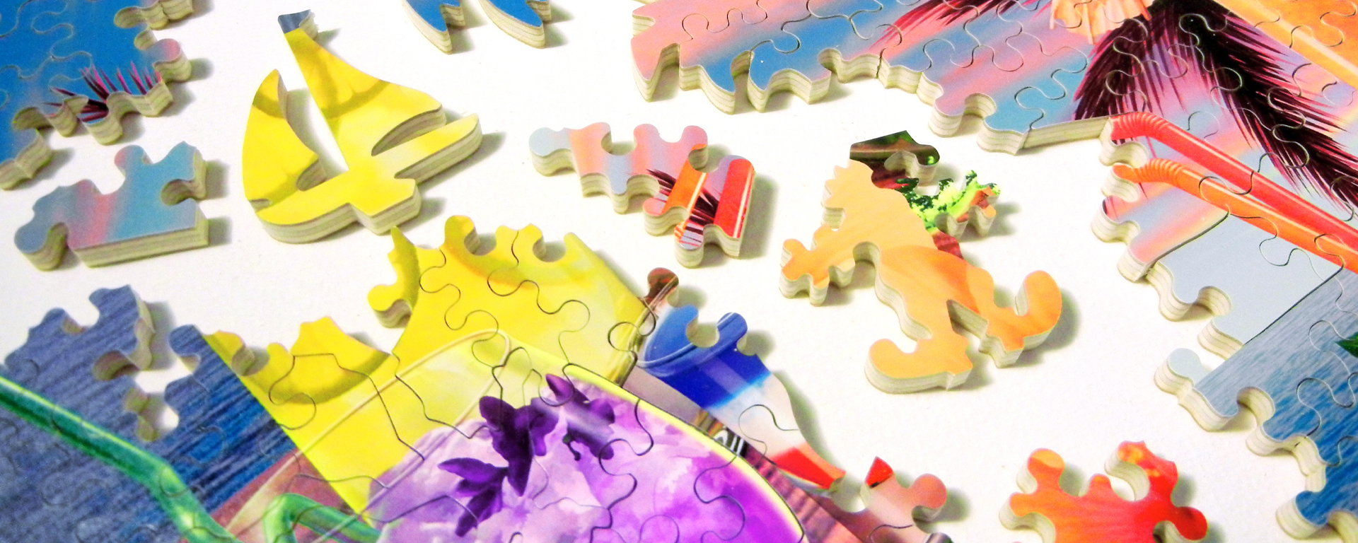 Wooden wine and beverage puzzle in progress featuring a tropical purple beverage with the beach and a beautiful sunset in the background.