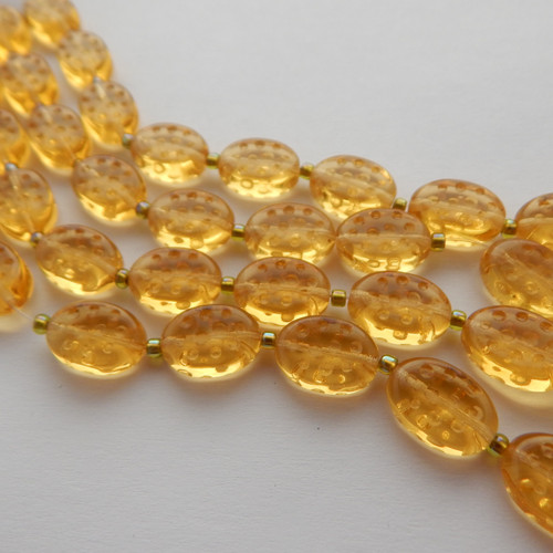 10x14mm Dimpled Oval Pressed Transparent Topaz Pressed Czech Glass (10 beads)