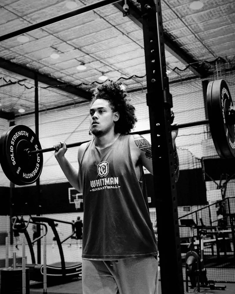 An athlete squatting in the strength room at The Swish Factory