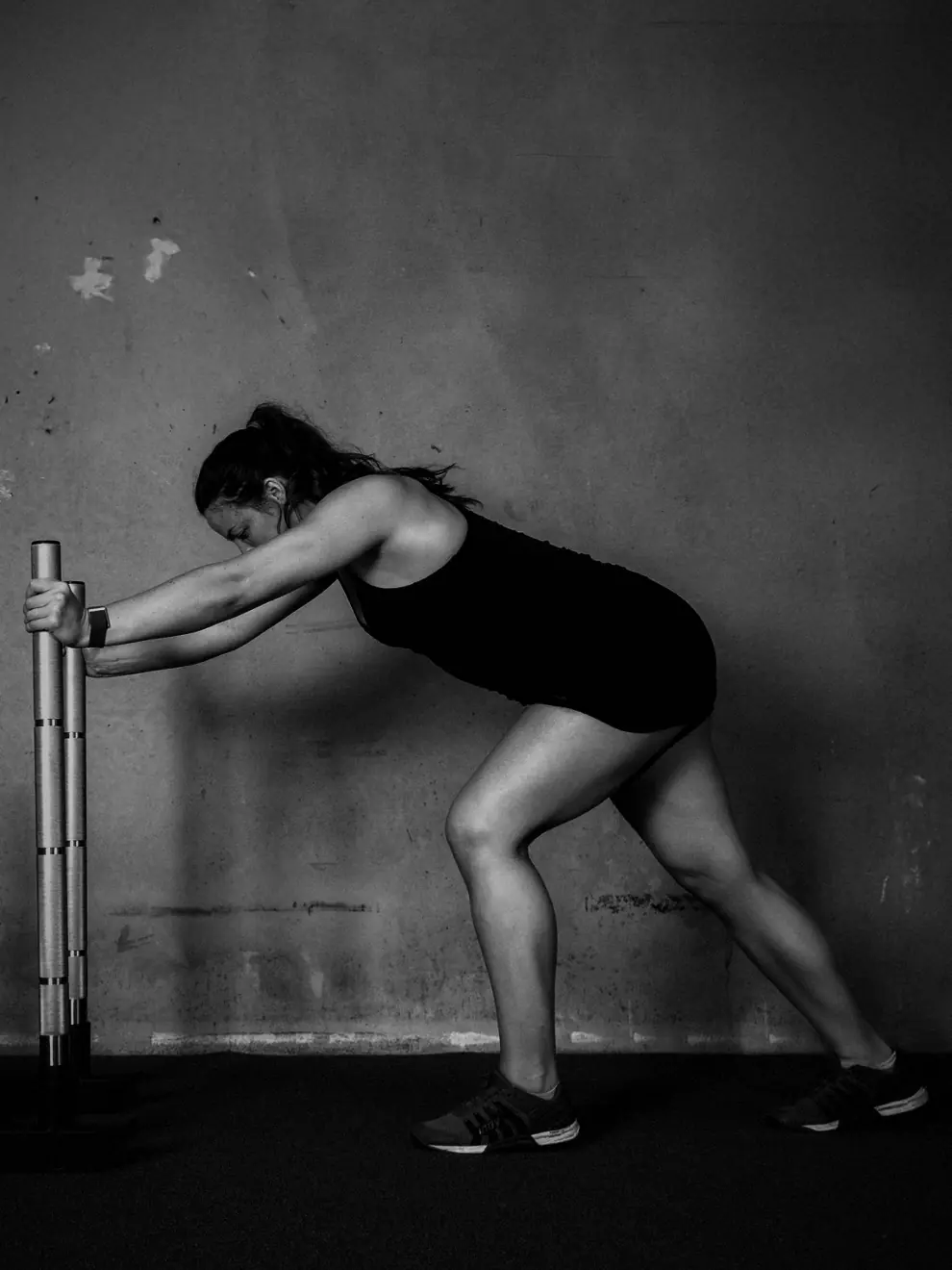 An athlete pushing a loaded Solid Strength sled