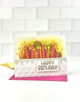 Handmade greeting card with candles on it and happy birthday sentiment on it.
