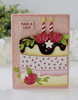 Handmade greeting card with cake on it and candles with make a wish sentiment on it.