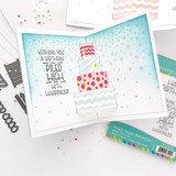 Inside of a handmade greeting card with cake on it and wishing you a birthday piled high with happiness sentiment on it.