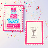 Handmade greeting card with cake on it and another card next to it with wishing you a birthday piled high with happiness on it.