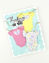 Handmade greeting card with onesies on it and thinking of you sentiment on it.
