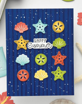 Handmade greeting card with seashells on it and happy summer sentiment on it.