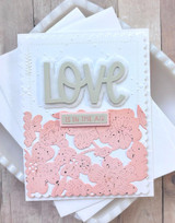 Handmade greeting card with hearts on it and love is in the air sentiment on it.