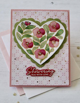 Handmade greeting card with floral heart on it and showering you with love sentiment on it.