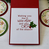 Inside of a greeting card with wishing you the wonder and joy of the season sentiment on it.