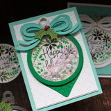 Handmade greeting card with ornament on it and happy holidays sentiment on it.