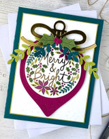 Handmade greeting card with ornament on it and merry & bright sentiment on it.