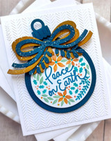 Handmade greeting card with ornament on it and peace on earth sentiment on it.