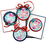 Four handmade greeting cards and tags with ornaments and various Christmas sentiments on each.