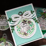 Handmade greeting card with ornament on it and peace on earth sentiment on it.