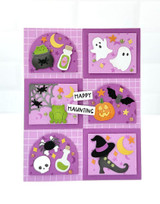 Handmade greeting card with potions, bats, ghosts, and pumpkins on it and happy haunting sentiment on it.