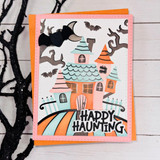 Handmade greeting card with haunted house on it and happy haunting sentiment on it.
