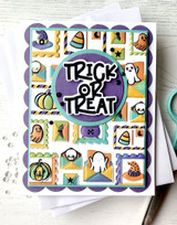 Handmade greeting card with halloween postage items on it and trick or treat sentiment on it.