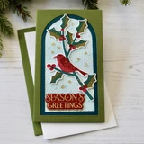 Handmade greeting card with cardinal on it and season's greetings sentiment on it.