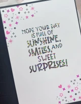 Inside of a handmade greeting card with hope your day is full of sunshine, smiles and sweet surprises sentiment on it.