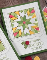 Handmade greeting card with quilt on it and sending warm wishes sentiment on it.