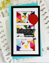 Handmade greeting card with triangles on it and a balloon with happy birthday sentiment on it.