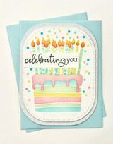 Handmade greeting card with cake on it and celebrating you sentiment on it.