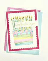 Handmade greeting card with cake on it and celebrating you sentiment on it.
