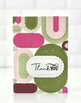 Handmade greeting card with oval capsules on it and thank you sentiment on it.