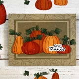 Handmade greeting card with pumpkins on it and give thanks sentiment on it.