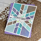 Handmade greeting card with snowflake pattern on it and season's greetings sentiment on it.