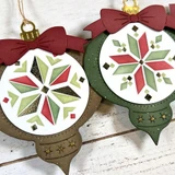 Two handmade ornament tags with patterns on each.