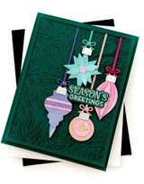 Handmade greeting card with ornaments on it and season's greetings sentiment on it.