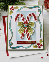 Handmade greeting card with candy cane on it and season's greetings sentiment on it.