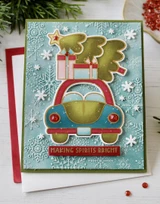 Handmade greeting card with car and tree on it and making spirits bright sentiment on it.