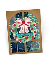 Handmade greeting card with wreath on it and season's greetings sentiment on it.