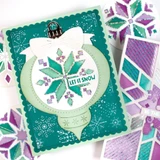 Handmade greeting card with ornament on it and pattern with let it snow sentiment on it.
