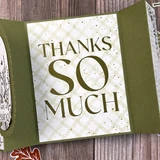 Handmade thank you card featuring a bold Thanks So Much sentiment in white and gold against a textured olive green background.