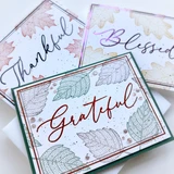 Handmade greeting card featuring a jewel-toned Grateful sentiment surrounded by delicate floral patterns and decorative framing.