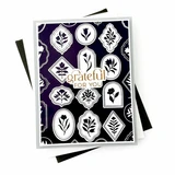 Handmade gratitude card featuring white and purple botanical medallions against a black background with a Grateful sentiment.