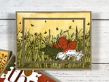 Handmade autumn greeting card featuring a foiled wildflower meadow, colorful fall foliage, pumpkins, and a warm golden background.